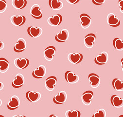 Endless seamless pattern of hearts of different directions. Red vector hearts on pink. Wallpaper for wrapping paper. Background for Valentine's Day