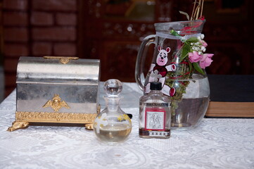 Water of holy basil, tulsi or Ocimum tenuiflorum in a transparent glass in a  church in Romania