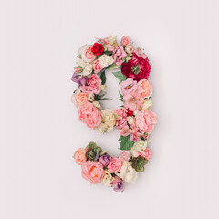 Number 9 made of real natural flowers and leaves. Flower font concept. Unique collection of letters and numbers. Spring, summer and valentines creative idea.