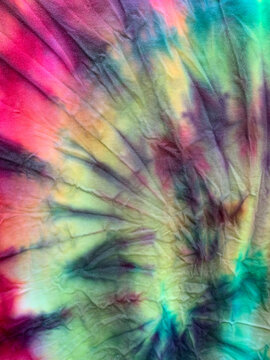 Closeup up of Red, yellow, green, and black tye-dyed t-shirt