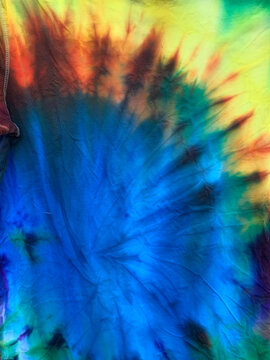 Bright blue, green, orange, and yellow patterned Tye Dye T-shirts