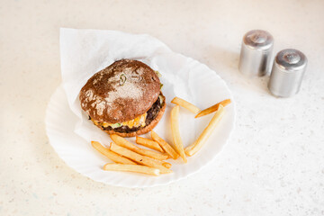 Burger with French fries in form of heart. Food love concept. Romantic meal. Homemade fast food.