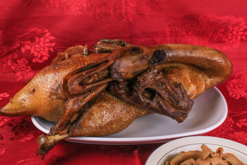 Delicious golden brown duck or steamed duck in Paloe or Lou mei Sauce (Thai name is Pedpalow) for Offering Sacrifices On Chinese New Year on red background.