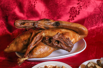 Delicious golden brown duck or steamed duck in Paloe or Lou mei Sauce (Thai name is Pedpalow) for Offering Sacrifices On Chinese New Year on red background.