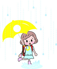雨の日に傘をさして歩く小学生の女の子