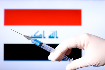 Hand holding syringe with covid vaccine