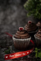 Valentines day Chocolate Cupcakes on dark moody setting, selective focus