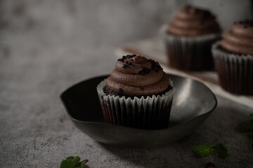 Chocolate Cupcakes on dark moody background, selective focus