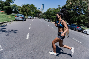 woman running in the middle of a city street