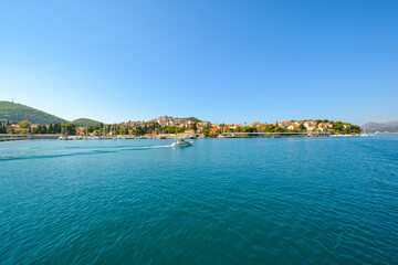 Fototapeta na wymiar A small motorboat cruises along the Dalmatian Coast of Dubrovnik, Croatia, on the Adriatic Sea.