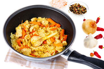 Pilaf. Rice with meat and vegetables in frying pan on white background. Studio Photo