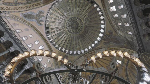 Interior of pompous palace with beautiful chandelier. Action. Bottom view of magnificent castle ceiling, concept of architecture. 