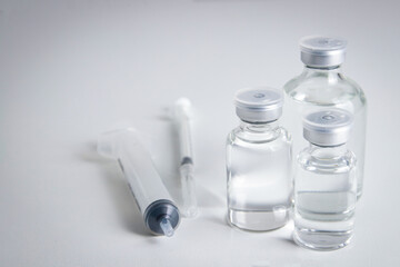 Anti-virus vaccine bottle with syringe Placed on a white background Concept of vaccine for the coronavirus, or COVID-19. Hospital medical services. Copy space