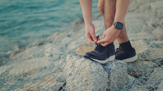 Asian Man Sporty Tying Jogging Shoes Prepare Ready For Running Outdoors At The Seaside.