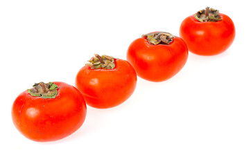 Heap of ripe sweet orange persimmons isolated on white background. Studio Photo
