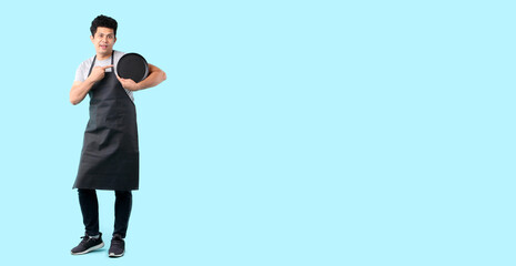 Dining concept. Asian man waiter holding an empty plate.isolated on blue background in studio With copy space.