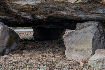 View under a dolmen capstone sitting on smaller boulders.
