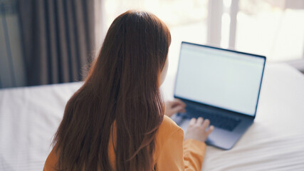 woman at laptop or already in bed rest internet work