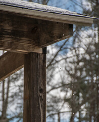 snow on top of a roof is melting 