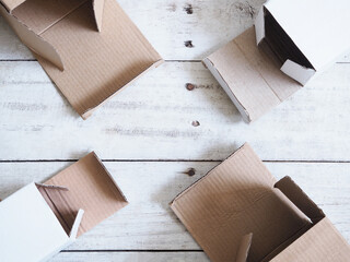 Top view of opened deliverly brown corrugated cardboard box on wooden background.