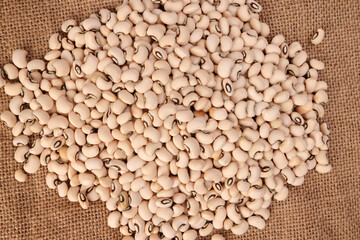 Blackeye beans on jute yarn fabric background