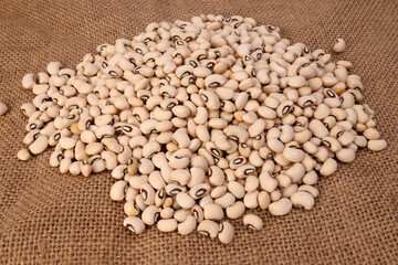 Blackeye beans on jute yarn fabric background