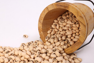 Blackeye beans in wooden small bucket on white background