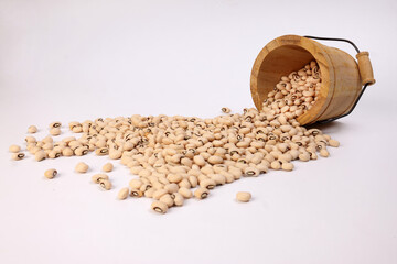 Blackeye beans in wooden small bucket on white background