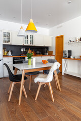 Modern design interior of dining room, kitchen, white furniture