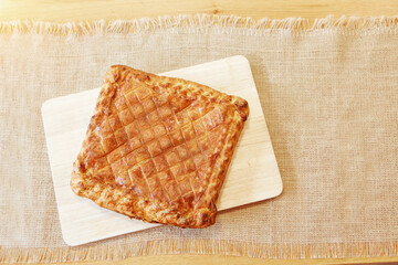 Pie on a chopping board. The food is ready to eat. Puff Pastry pastry