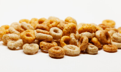 a pile of round breakfast cereals on a white background