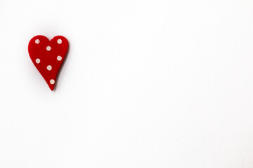 A small, miniature polka dot heart on a white background, isolated, valentine's day 2021 themed concept. 