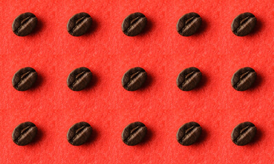 Pattern of roasted coffee beans on a red fluffy fabric.