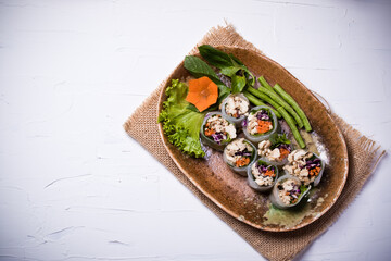 Suan Noodle with chicken and vegetables in a plate on a white background.