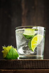 Rum based cocktail caipirinha (variation of cuba libre) on the rustic background. Selective focus. Shallow depth of field.