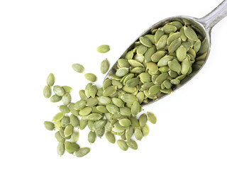 Peeled organic pumpkin seeds in metal scoop isolated on white background for pumpkin seeds can improve health concept.
