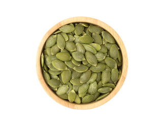 Organic pumpkin seeds in circle shaped wooden bowl top view isolated on white background. Organic pumpkin seeds healthy ingredients food concept.