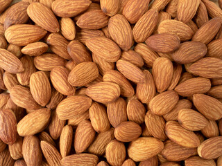 Organic raw peeled almond nuts as background, top view.  Vegetarian snack or Healthy food concept .