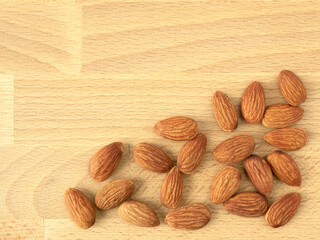 Organic almonds nuts on wooden table with copy space. Top view. Flat lay. Set or collection for healthy nuts and vegetarian food concept.