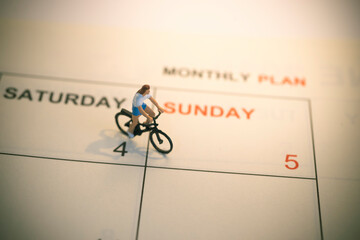 Girl riding bicycle with vintage weekend calendar