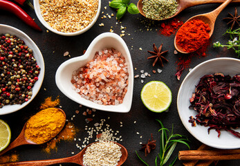 Colorful and aromatic herbs and spices on a dark background