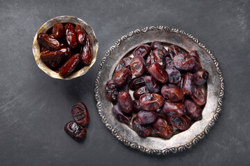 The meal eaten by Muslims after sunset during Ramadan on gray background.