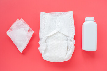 Composition with baby accessories and cosmetics for child care on a pink background, flat flat, top view, layout. Trendy background, hygiene of newborn girls