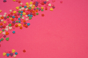 Small colorful candies, Heart and star shapes, on a pink background. Valentine day. About love. copy space. High quality photo