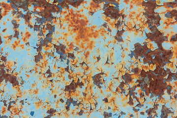 An old blue painted wall with spots and streaks of rust.Rusty metal background. Rust stains.