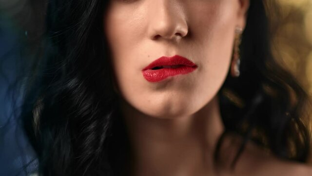 Closeup sexy brunette woman licking tongue biting red lips posing disco bokeh. 4k Dragon RED camera