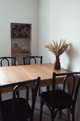 Wooden Table in kithen with dry grass vase, minimalist interior