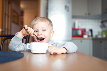 cute boy eating at the kitchen