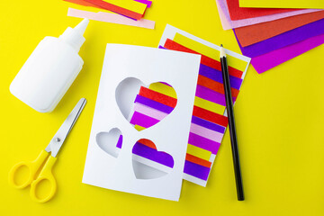 DIY step 7, step-by-step instructions for a paper card for mother's holiday, valentine's day, heart made of multi-colored stripes