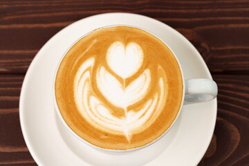 Cup of hot coffee latte on table